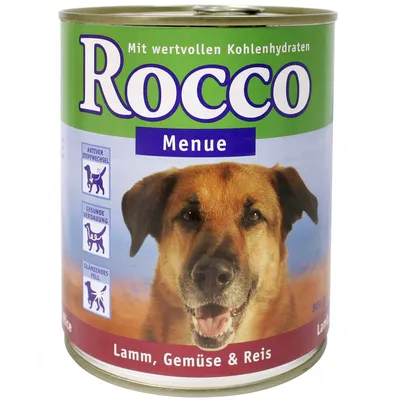 Rocco Menue hondenvoer, met waardevolle koolhydraten. Lamsvlees, groente & rijst. Pictogrammen: actief metabolisme, gezonde vertering, glanzende vacht. Tekst in het Duits.