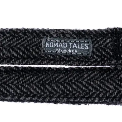 Nomad Tales München. Black textile collar with herringbone pattern and brand label.
