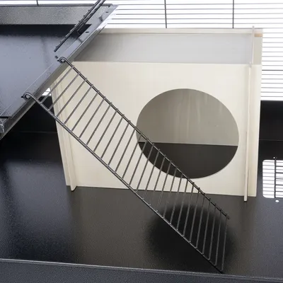 Wooden house with round entrance and metal ramp, suitable for small animal cages. Detailed view of the construction.