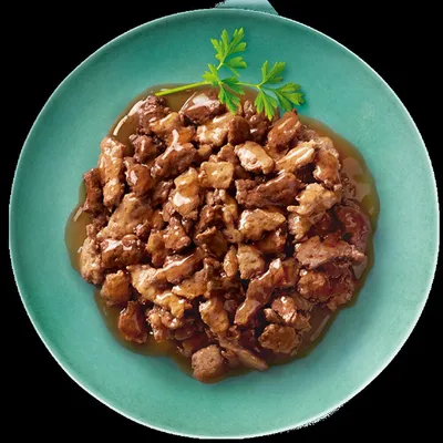 Chunks of meat in gravy served on a green plate, garnished with fresh parsley.
