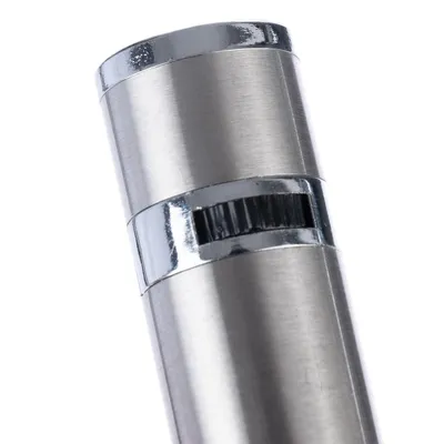 Close-up view of a cylindrical metal product with shiny chrome accents and a ribbed twist mechanism.
