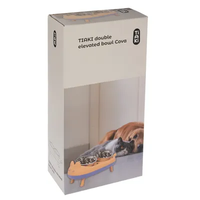 Packaging of Tiaki double elevated bowl Cova, orange elevated double feeding bowl with cat motif. A dog and a cat are shown next to the bowl.