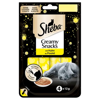 Sheba Creamy Snacks mit Huhn au Poulet, 4×12g, bez přidaného cukru. Obal s obrázkem kočky a misky s krémovou pochoutkou. Text: Fütterung per Hand / Se donne à la main.
