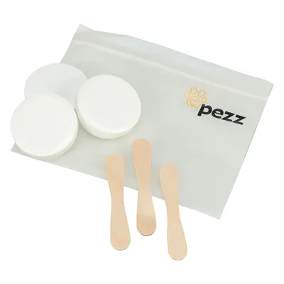 Pezz set med tre träspatlar, två vita burkar och en genomskinlig zip-väska med Pezz-logotyp.