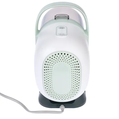 Portable air purifier with white-green design, integrated handle and power cable connection. Visible controls on top.