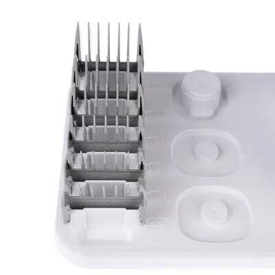 Set of five grey clip-on combs with size markings: 3mm, 6mm, 9mm, 12mm and 18mm. White plastic holder for organised storage.