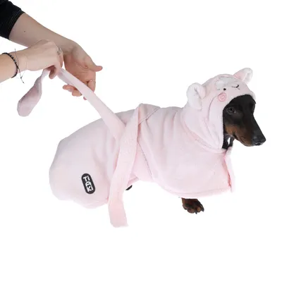 Dog coat in pink with hood and ears, brand Trixi. Hand holding the coat's tail.