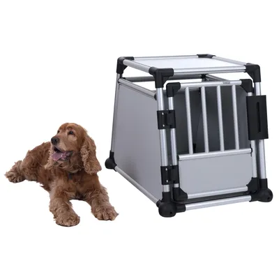 Transport box made of aluminium with grid door and sturdy corners, suitable for pets. Dog shown next to the box.