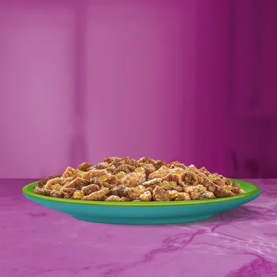 Chunks of moist food served on a green plate, showing texture and portion size for product evaluation.