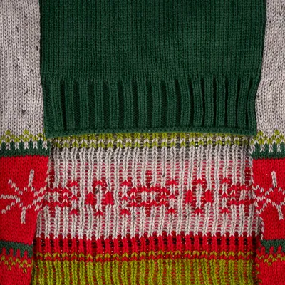 Nahaufnahme eines gestrickten Materials mit grünem, rotem und weissem Muster, einschliesslich Schneeflocken-Designs.