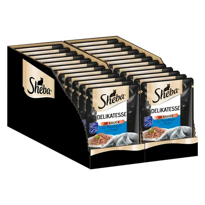 Boîte de sachets Sheba Delikatesse in Sauce mit Thunfisch au Thon, emballage noir et doré, visuel de morceaux de thon en sauce et tête de chat gris sur le devant des sachets.