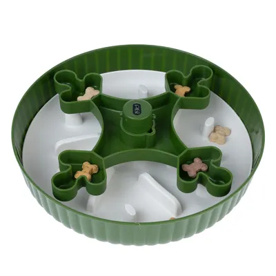 Green food dispenser with multiple chambers, filled with small dog bone treats. Round shape and white base visible.