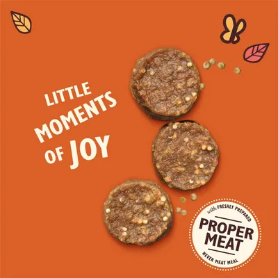 Three round meat treats with text: 'Little moments of joy' and a badge stating 'with freshly prepared proper meat, never meat meal'.