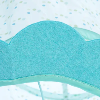 Close-up view of light blue felt material with a dotted background, possibly part of a pet product.