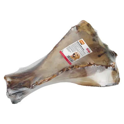 Упакованная говяжья кость с этикеткой Rocco, изображение собаки и штрихкодом на упаковке. Видна прозрачная пленка.