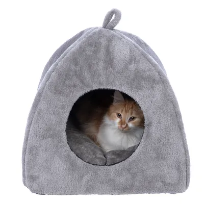 Grey, soft cat house with round entrance. A red and white cat is lying inside on a padded cushion.