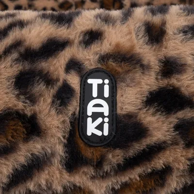 Tiaki logo on a leopard print faux fur background.