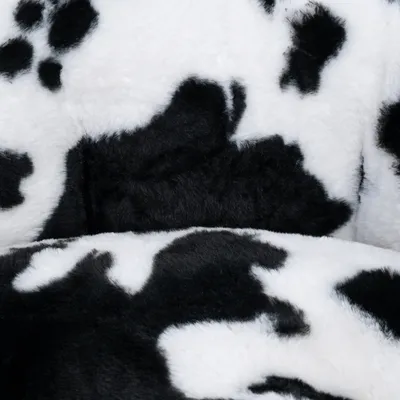 Close-up of black and white patterned plush material, possibly for pet products such as beds or blankets.