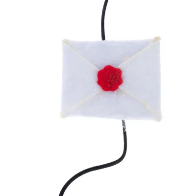 Toy shaped like a white felt letter with red seal, attached to a black cord.