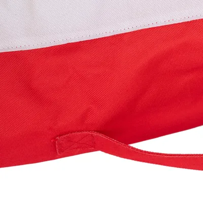 Détail d’un tissu rouge et blanc avec une sangle cousue, matière textile visible. Aucun logo ni texte apparent.
