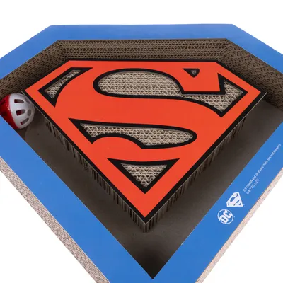 Krabplank van karton in Superman-logo vorm met rode speelbal. DC Comics licentieproduct.