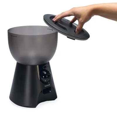 Automatische voerdispenser met afneembaar deksel, hand toont opening van de container. Merk: bestpets.