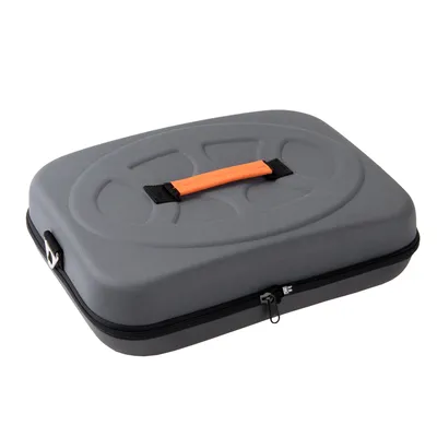 Mallette rigide grise avec poignée orange, fermeture éclair noire et coque en tissu, sans marque visible.