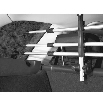 Adjustable car safety gates made of metal with plastic brackets, installed in the boot of a vehicle.