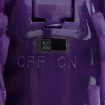 Close-up of a purple switch with the labels 'OFF' and 'ON'.