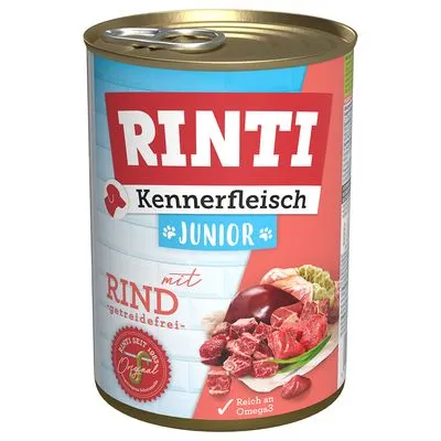 Blik Rinti Kennerfleisch Junior hondenvoer, met rund, graanvrij, rijk aan Omega3. Afbeelding van vlees en orgaanvlees op het etiket. Productinformatie zichtbaar op de voorkant.