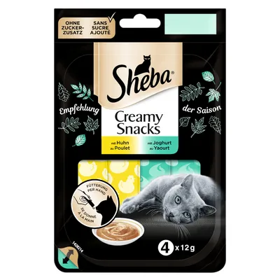 Sheba Creamy Snacks per gatti, senza zuccheri aggiunti, con pollo e yogurt, confezione da 4 x 12 g. Immagine di un gatto grigio e simbolo alimentazione a mano.