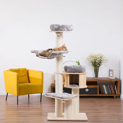 Cat tree with multiple levels, hammock and grey fabric resting areas. Bengal cat lying relaxed in the hammock.