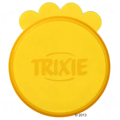 Yellow round plastic lid with scalloped edge and the word TRIXIE embossed in the centre, shown from above.