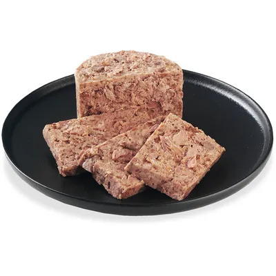 Close-up of sliced wet food on a black plate, showing the texture and composition of the food.