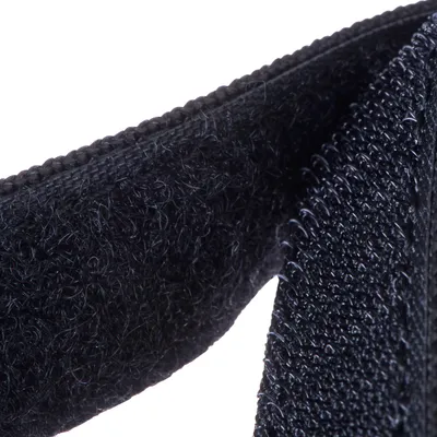 Close-up of a black hook and loop fastener with hook and soft sides.