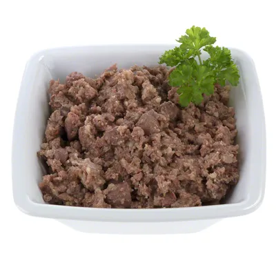 Bowl filled with minced meat pet food, garnished with a sprig of parsley.