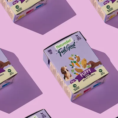 Naturediet Feel Good Puppy Chicken with Rice & Carrots, 390g. Only natural ingredients, gentle digestion. Product packaging shown on a purple background.