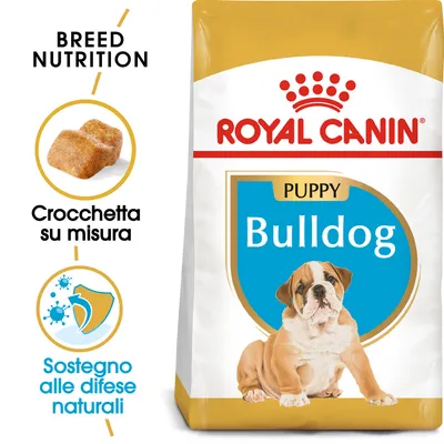 Royal Canin Puppy Bulldog, crocchetta su misura, sostegno alle difese naturali. Immagine di cucciolo di bulldog sulla confezione. Testo visibile: Breed Nutrition, Bulldog.