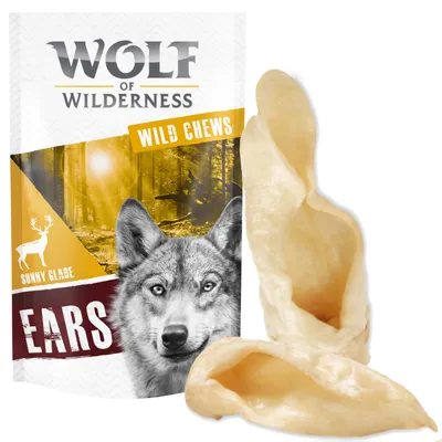 Wolf of Wilderness Wild Chews Sunny Glade Ears, two light-coloured ear-shaped chews shown beside branded packaging with forest and deer image.